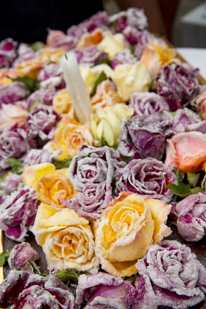 A collection of sugared roses. The roses are purple, pink and yellow