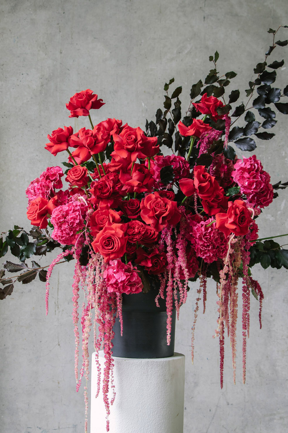 Luscious Floral Arrangement with Red Roses and Foliage by Flowers Vasette