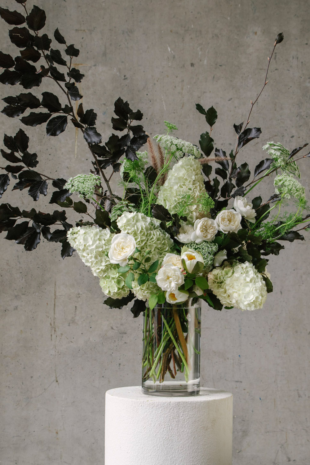 White and Green Floral Arrangement with Hydrangeas and Foliage